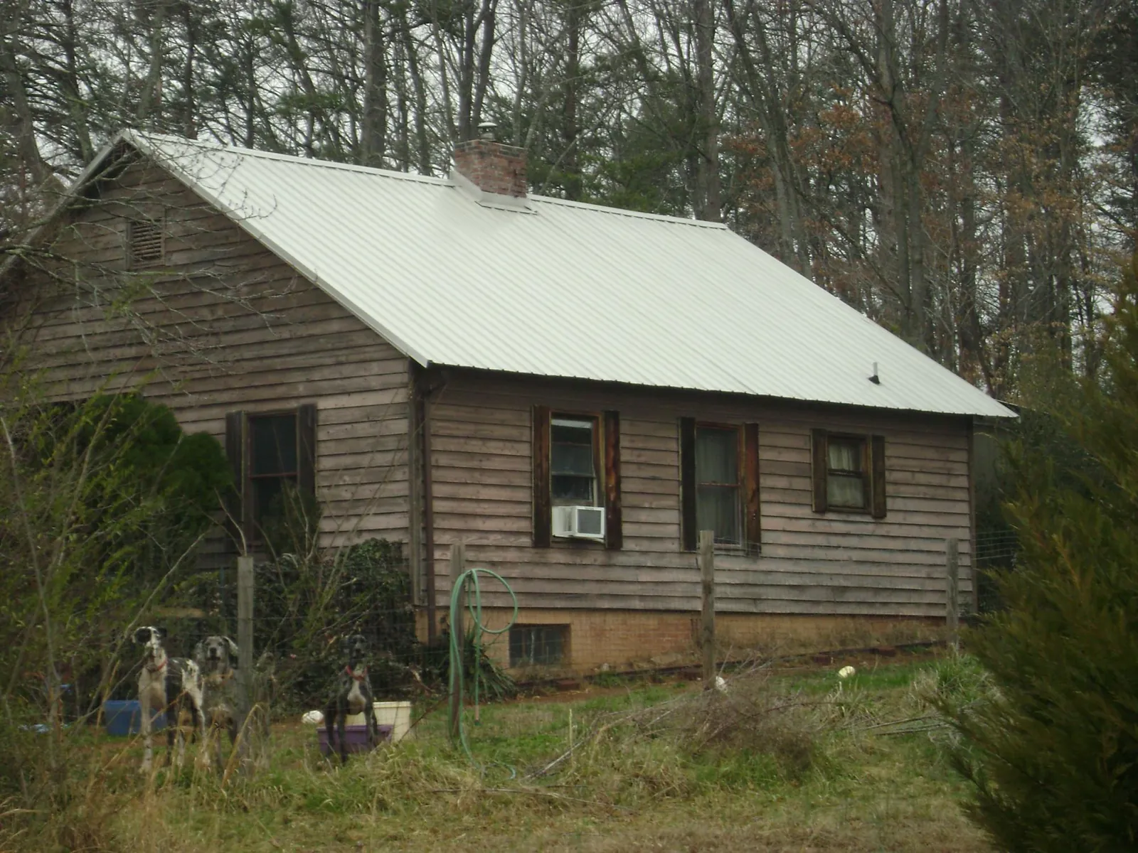 White metal roof on an old wood sided farmhouse, from a Metal Roof Installation job in Du Pont